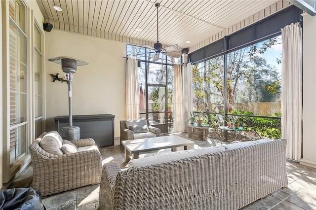 sunroom / solarium featuring wooden ceiling and a ceiling fan