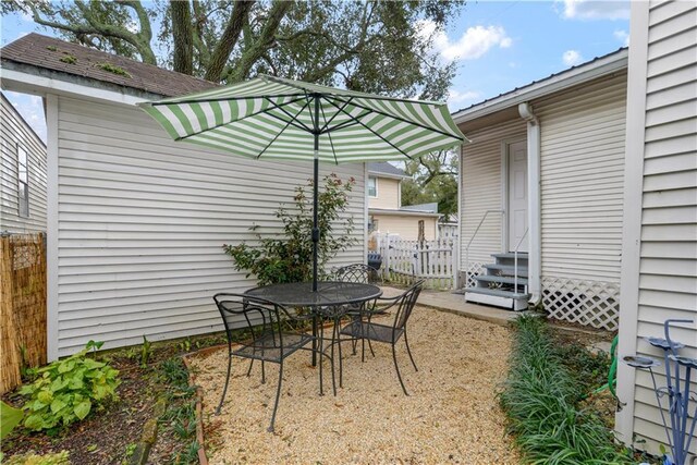 view of patio with entry steps and fence