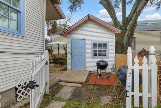 view of outbuilding featuring fence