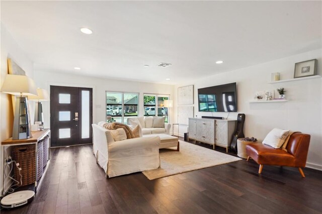 living room with recessed lighting, dark wood-style flooring, and visible vents