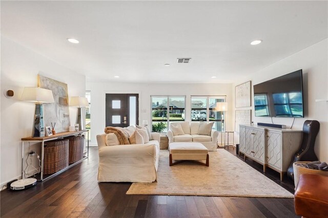 living room with hardwood / wood-style floors, visible vents, and recessed lighting