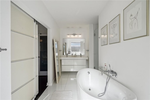 bathroom featuring a freestanding bath, a shower stall, vanity, and tile patterned floors