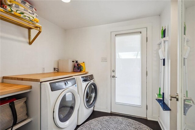 clothes washing area featuring laundry area and washing machine and clothes dryer