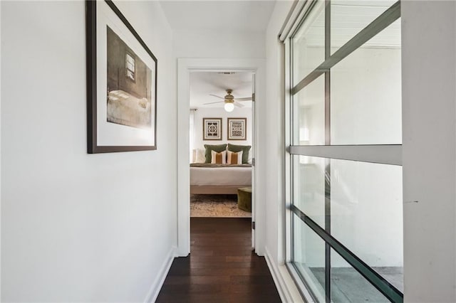 hall with dark wood-style floors and baseboards