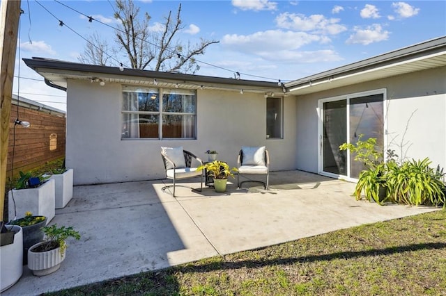 back of house with a patio and stucco siding