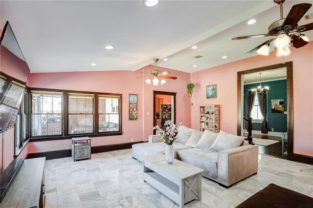 living area featuring lofted ceiling, a healthy amount of sunlight, baseboards, and recessed lighting