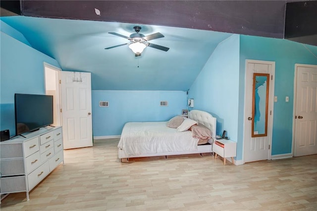 bedroom with baseboards, visible vents, a ceiling fan, lofted ceiling, and light wood-type flooring