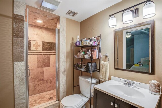 full bath with a stall shower, visible vents, toilet, ensuite bathroom, and vanity