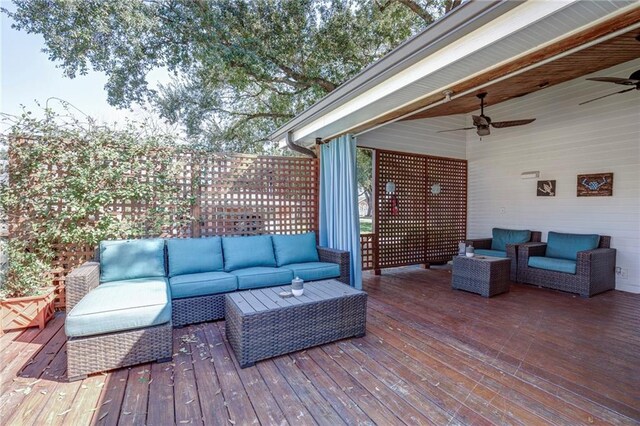 wooden deck featuring an outdoor hangout area and ceiling fan