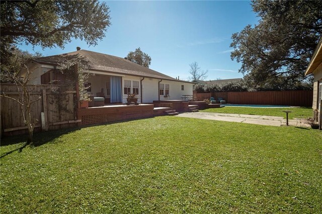 view of yard featuring a patio area, a fenced backyard, and a pool