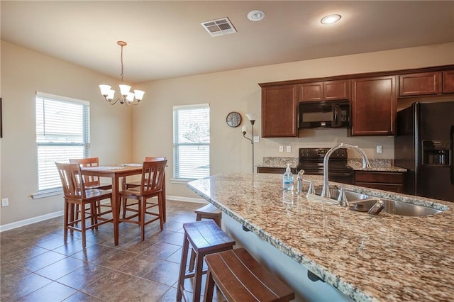 kitchen with plenty of natural light, visible vents, a sink, and black appliances