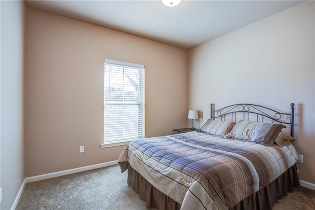 bedroom featuring carpet and baseboards