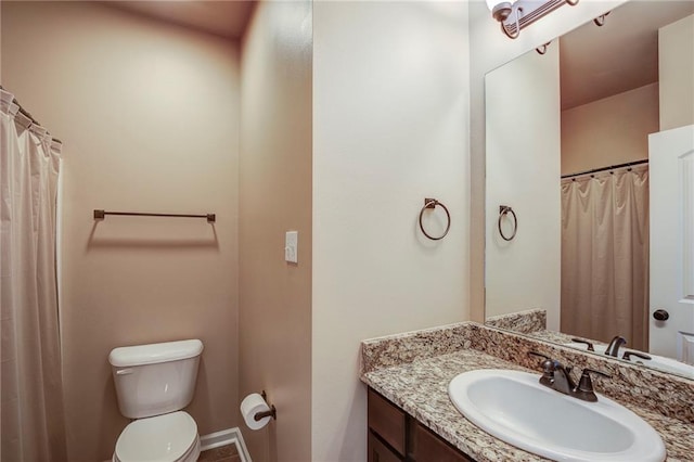 bathroom featuring toilet and vanity