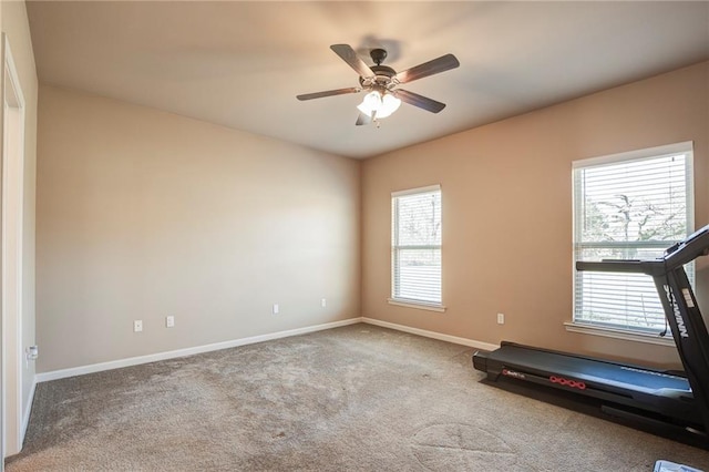 workout room featuring carpet flooring, a ceiling fan, and baseboards