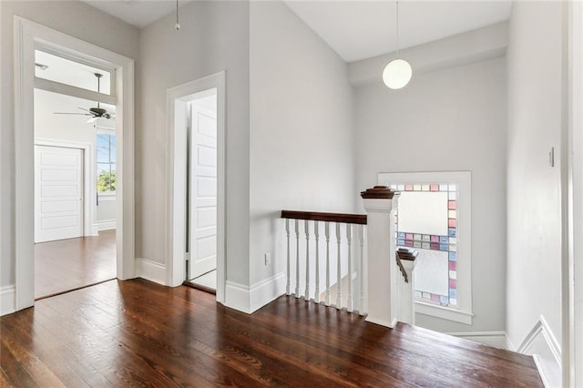 interior space with wood finished floors, an upstairs landing, and baseboards