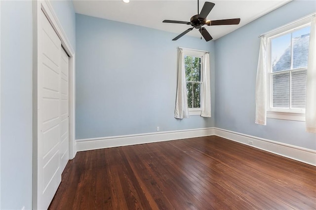 spare room featuring ceiling fan, wood finished floors, and baseboards