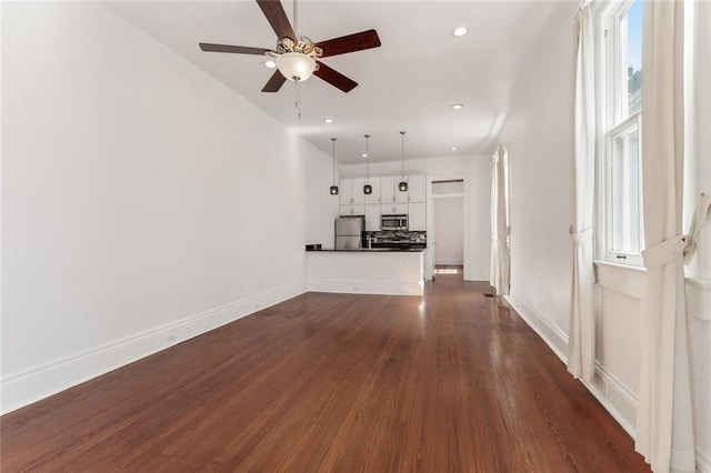 unfurnished living room with dark wood-style floors, ceiling fan, recessed lighting, and baseboards