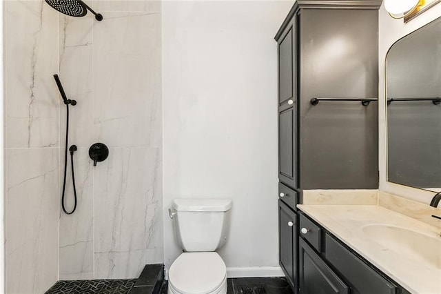 bathroom with vanity, a marble finish shower, toilet, and baseboards