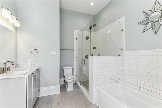 full bath with a garden tub, toilet, vanity, a shower stall, and tile patterned flooring