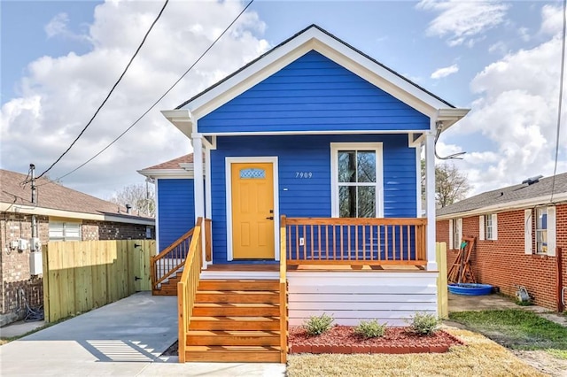 7909 Tarpon St, New Orleans, LA 70126 - shotgun-style home featuring a porch