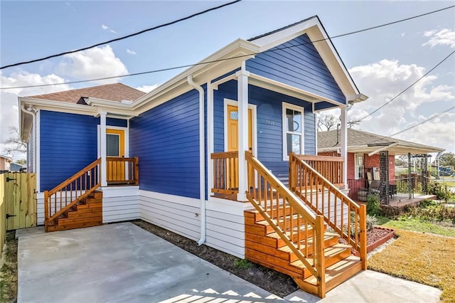 7909 Tarpon St, New Orleans, LA 70126 - view of front of house with a patio and roof with shingles
