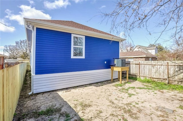 7909 Tarpon St, New Orleans, LA 70126 - back of house featuring a fenced backyard and roof with shingles