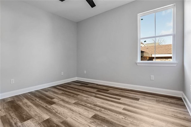 7909 Tarpon St, New Orleans, LA 70126 - empty room with a ceiling fan, dark wood-type flooring, and baseboards