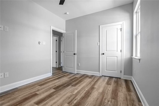 7909 Tarpon St, New Orleans, LA 70126 - unfurnished bedroom featuring wood finished floors, baseboards, and a ceiling fan