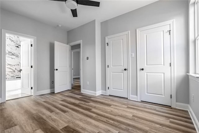 7909 Tarpon St, New Orleans, LA 70126 - unfurnished bedroom featuring wood finished floors, connected bathroom, and baseboards
