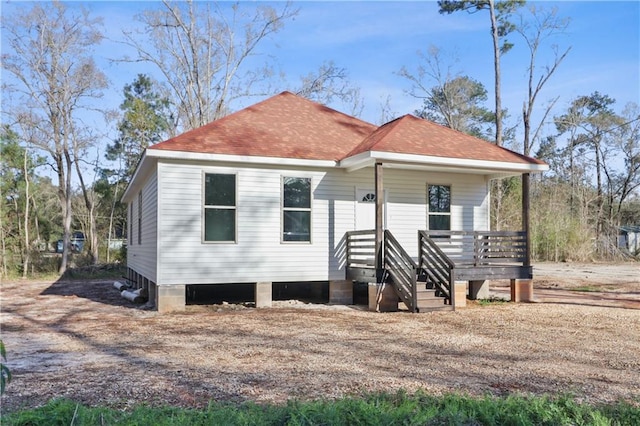 view of front of property featuring a porch and roof with shingles
