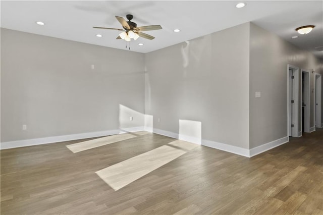 spare room with recessed lighting, a ceiling fan, and baseboards