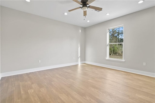 empty room featuring recessed lighting, a ceiling fan, baseboards, and light wood-style floors