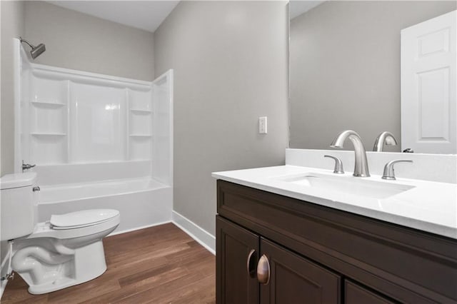 full bathroom featuring vanity, toilet, bathtub / shower combination, baseboards, and wood finished floors
