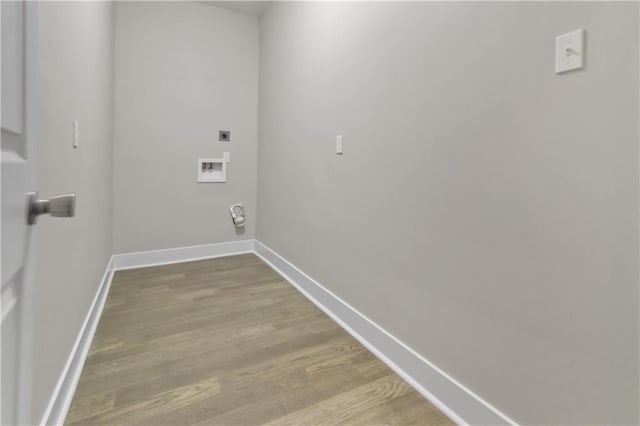 laundry area with hookup for an electric dryer, washer hookup, light wood-style flooring, baseboards, and laundry area