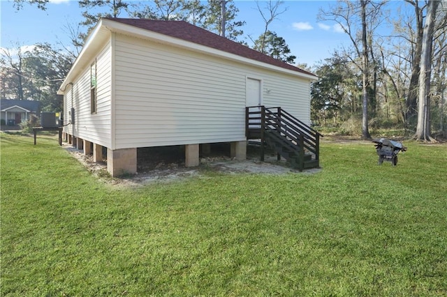 view of side of property featuring a yard