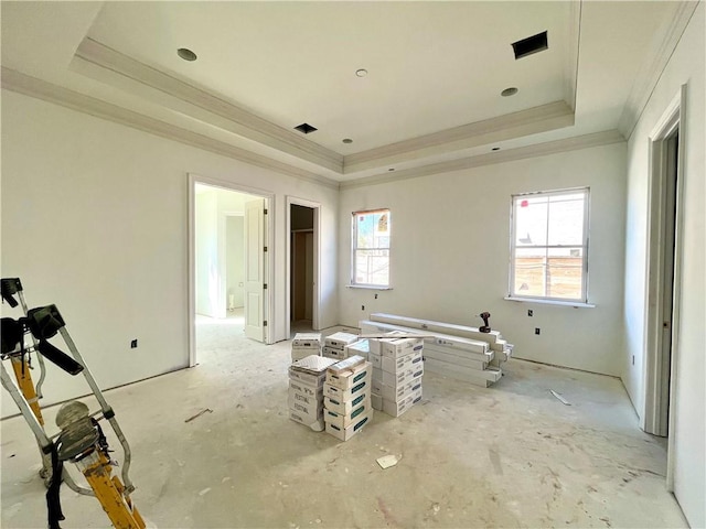 spare room with visible vents, a tray ceiling, and crown molding