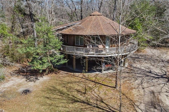 back of house with a wooden deck