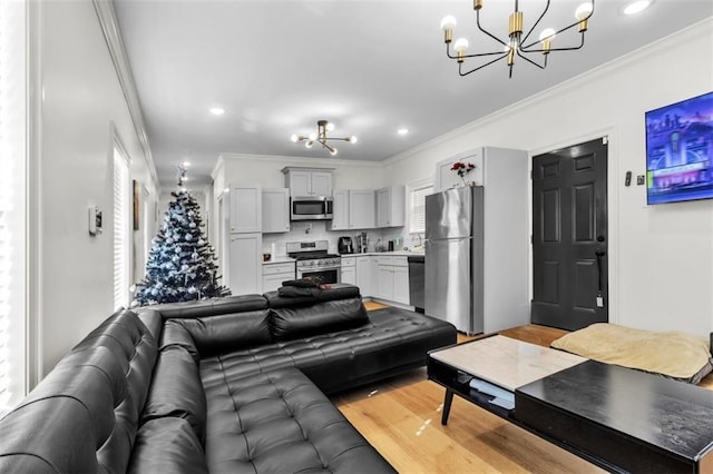 living area featuring a chandelier, ornamental molding, and recessed lighting