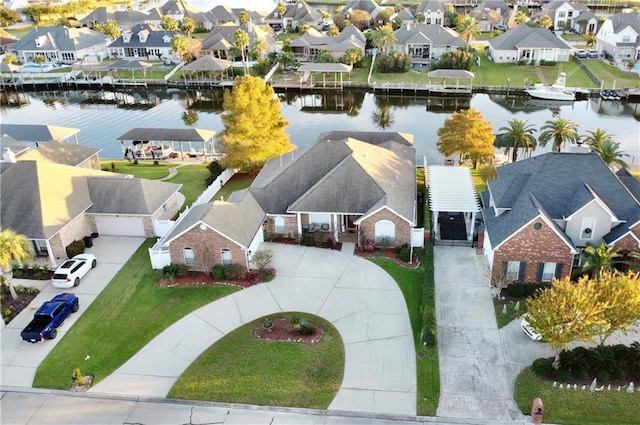 bird's eye view featuring a water view and a residential view