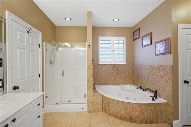 full bathroom with a tub with jets, a stall shower, tile patterned flooring, and vanity