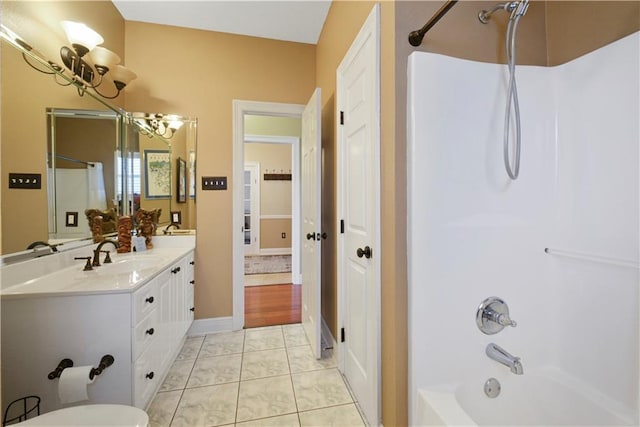 full bathroom featuring double vanity, shower / tub combination, a sink, and tile patterned floors