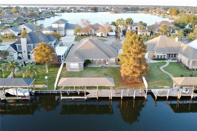 birds eye view of property with a water view and a residential view