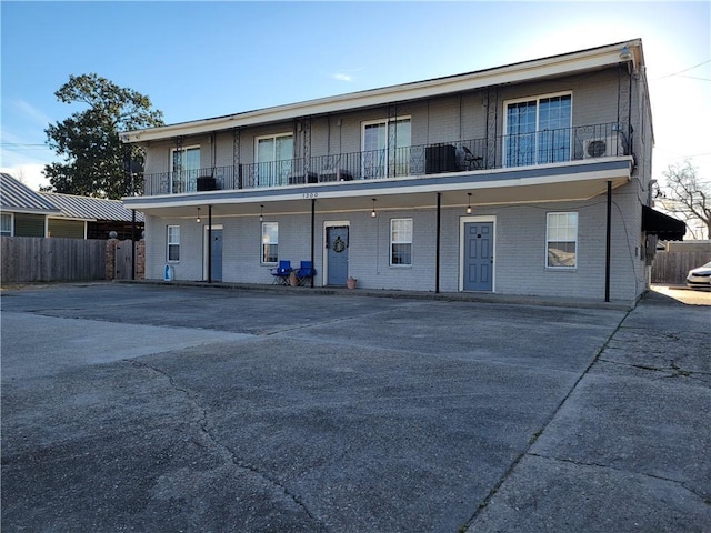 exterior space with brick siding and fence