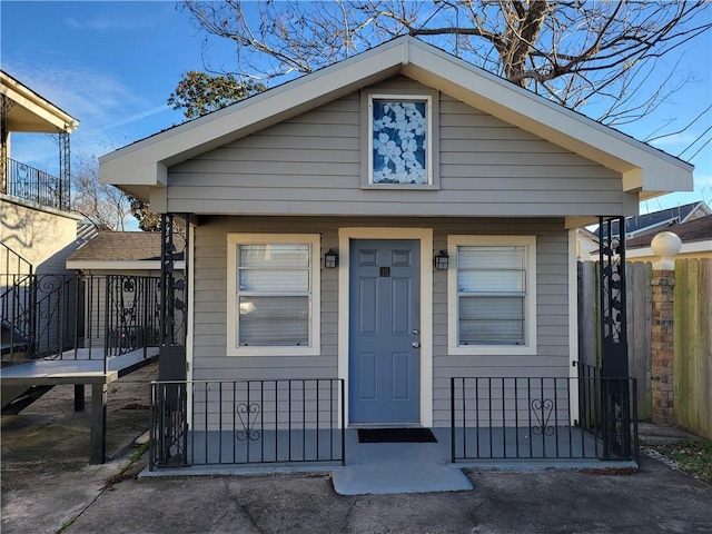 view of front of home featuring fence