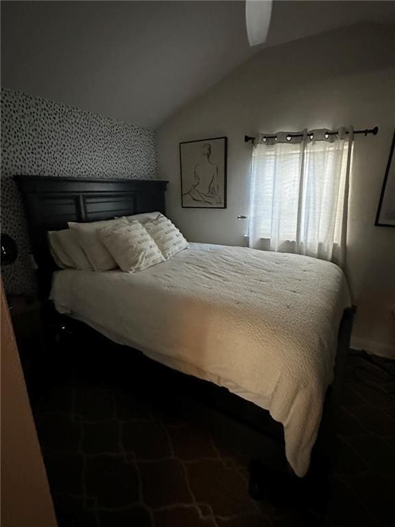 bedroom with lofted ceiling