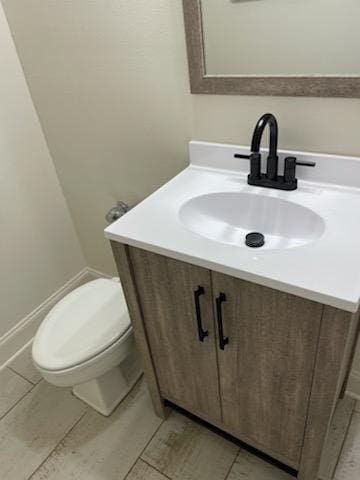 bathroom featuring toilet and vanity