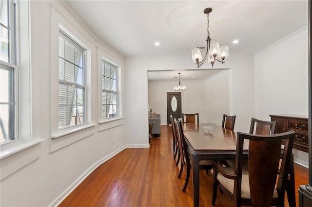 dining area featuring baseboards, a chandelier, wood finished floors, and recessed lighting