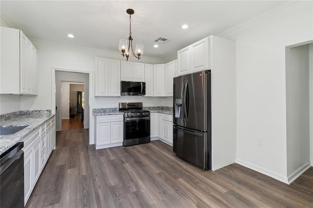 kitchen with visible vents, light stone counters, dark wood-type flooring, stainless steel appliances, and white cabinetry