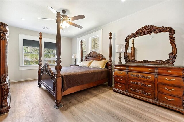 bedroom with visible vents, ornamental molding, a ceiling fan, light wood-type flooring, and baseboards