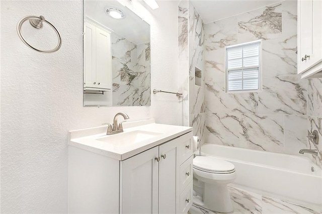 bathroom with a textured wall, toilet, marble finish floor, tub / shower combination, and vanity